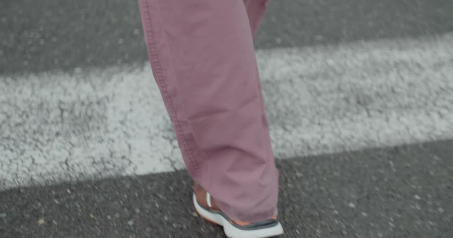 A man wearing hospital scrubs walks into an emergency room