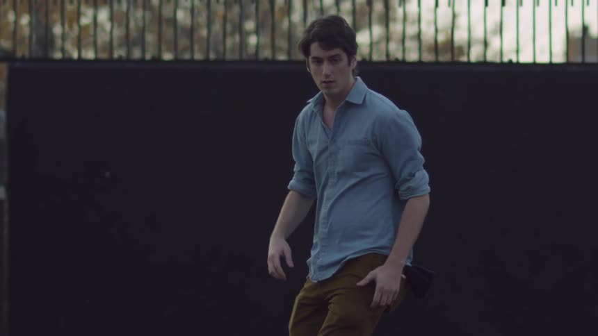 A man pushes off and rides on a skateboard