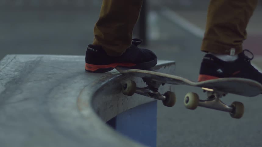 A skateboarder grinds the edge of a bench