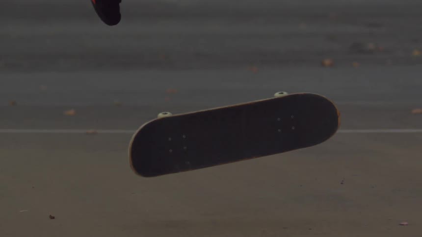 Footage of a young man attempting to perform a skateboard trick and nearly falling before he catches his balance