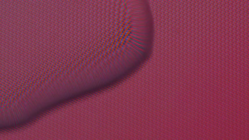 A pixel filled screen has a bubble on the top that is moving