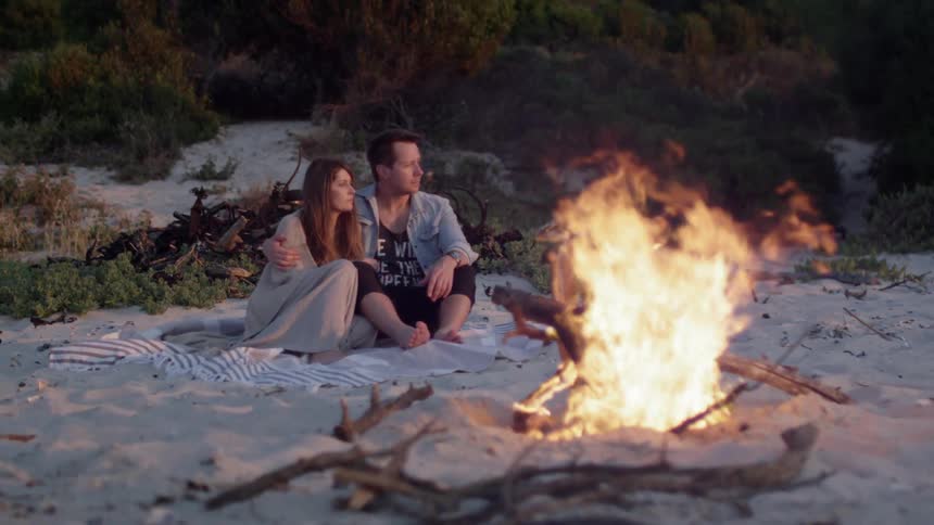 Couple Around Fire In Desert