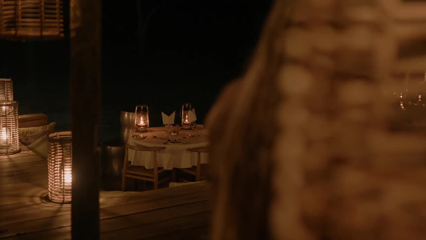 A woman looks at set tables in a restaurant