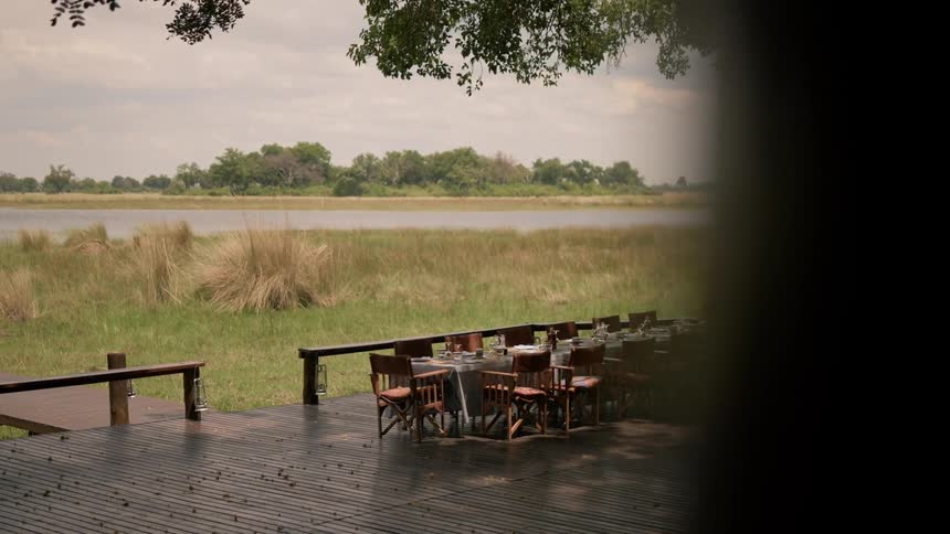 Long table on deck in front of river