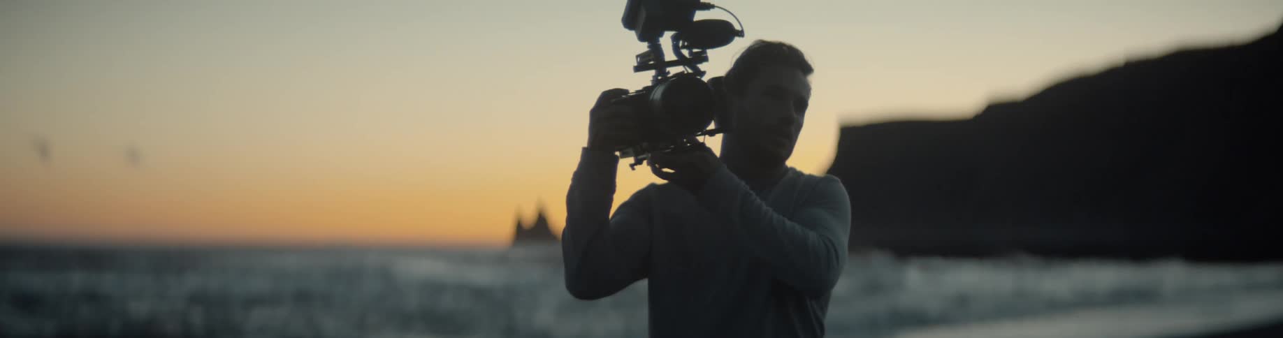 A man walks with his camera