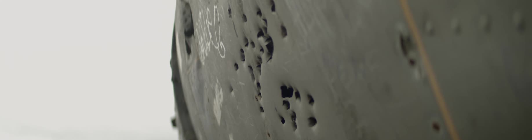Bullet holes in metal frame of vehicle