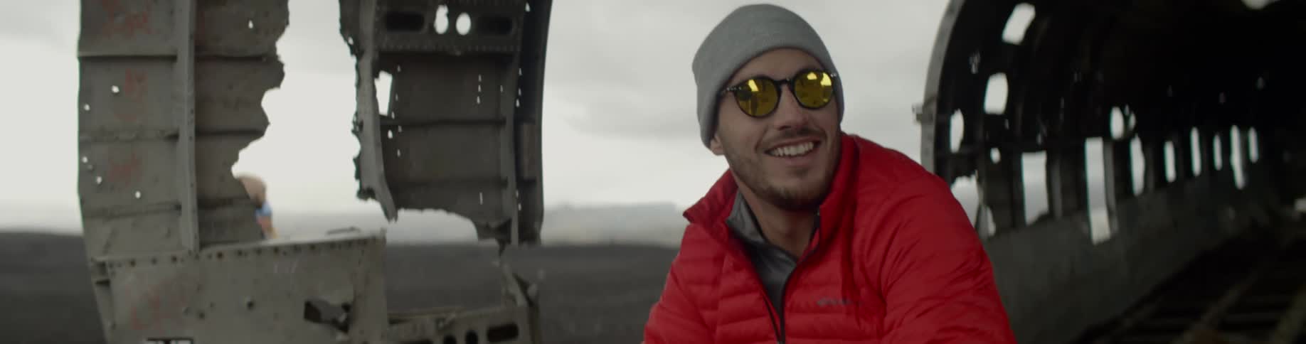 A man smiles in the damaged plane