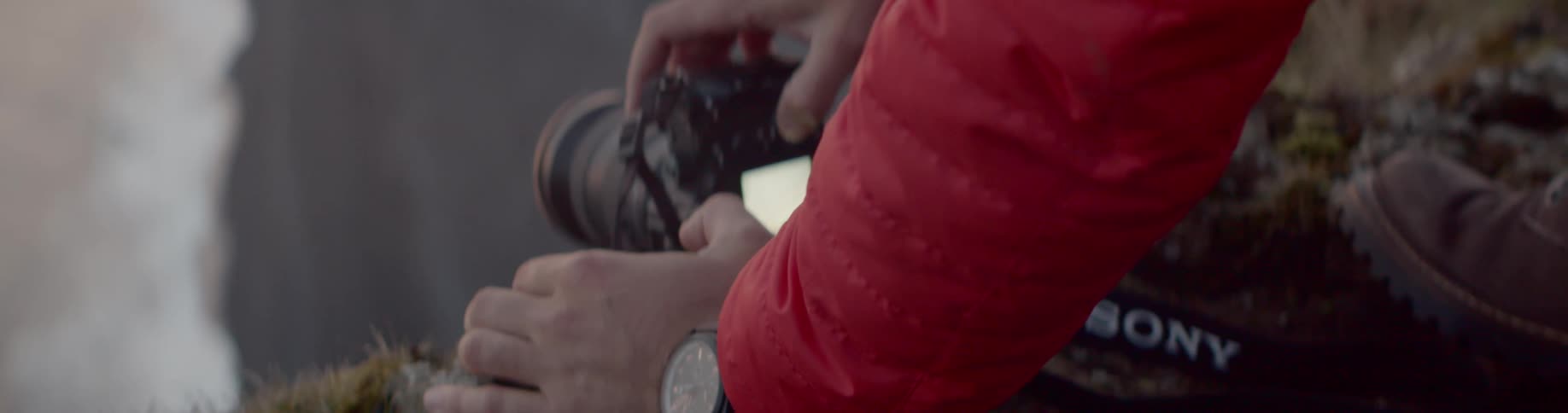 A young man sets up his camera to take a photo