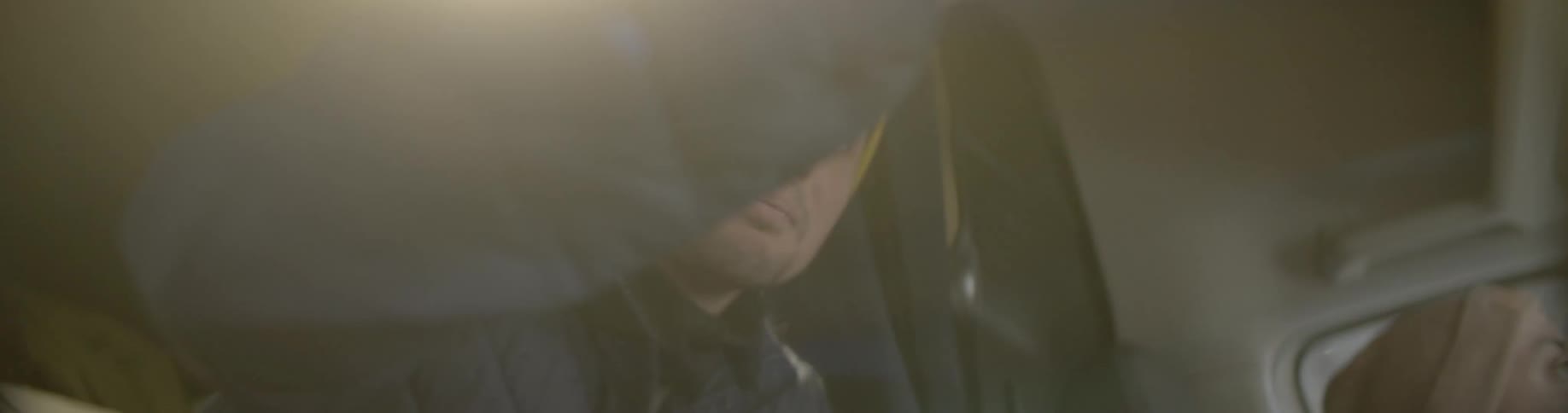 Two young man inside a van talking while driving
