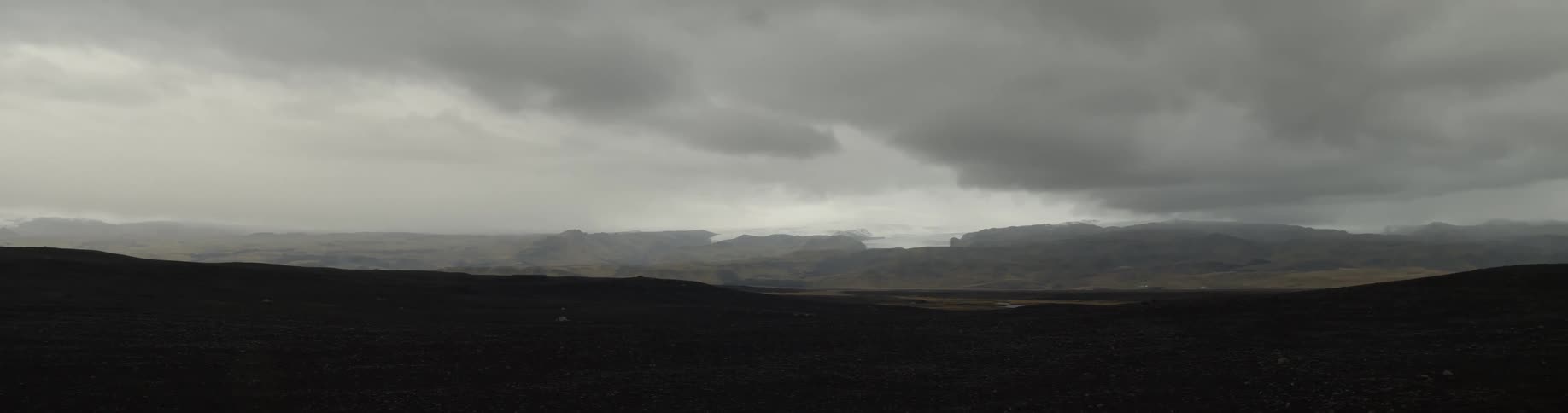 A person is walking on a long dark field
