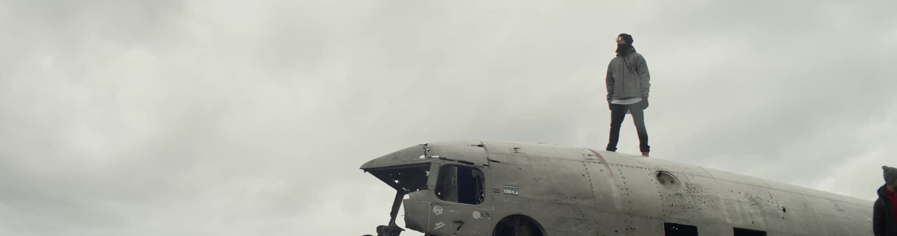 A man stands on top of an airplane that has no nose on the front