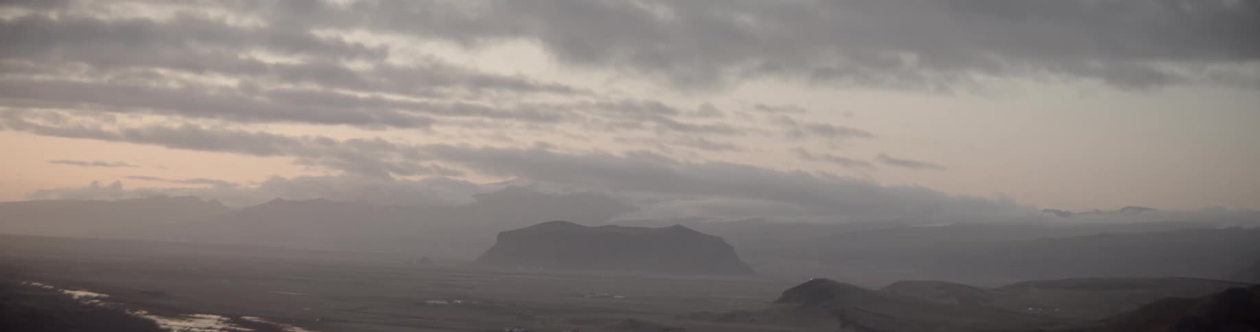 Landscape view of a solitaire mountain on a valley at sunset