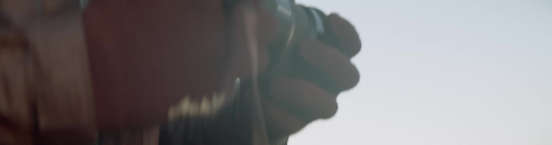 Photographers exchanging lenses then attaching to their own camera while outdoors