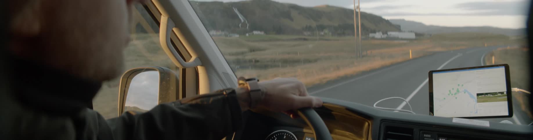 A man drives his vehicle down a road