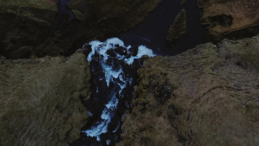 A river rushes over a cliff to form a waterfall