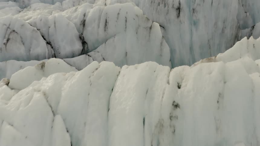 Crevices and caves in glacier near mountain