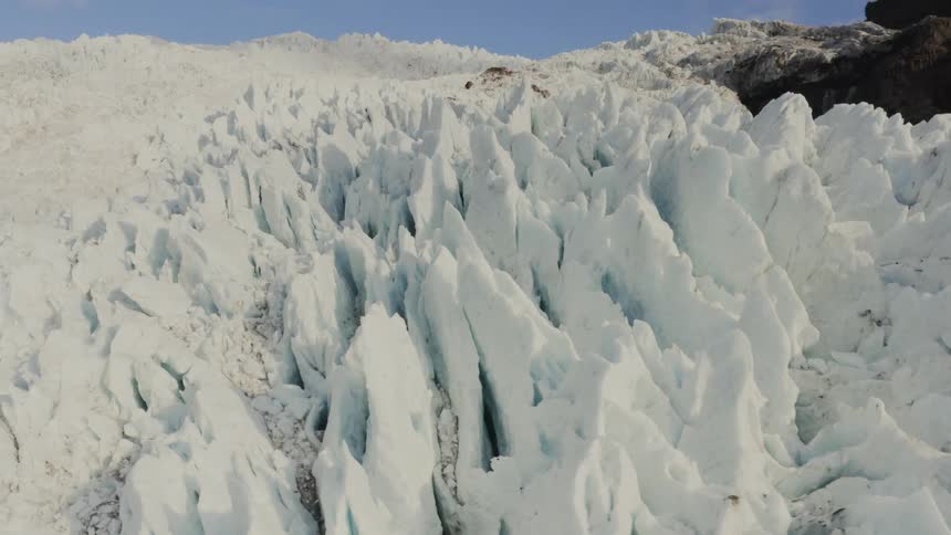 Ice forms peaks on a mountain slope