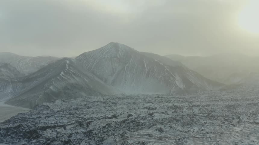 Landscape view of the sun over snow covered mountains