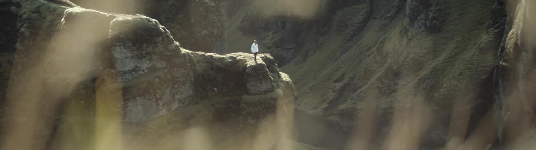 A person is climbing over the mountains ahead