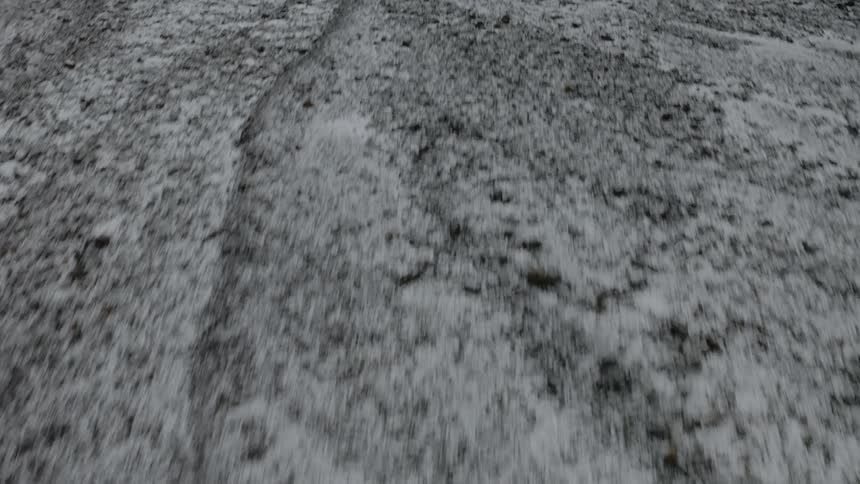 Footage of snow covered land with a vehicle parked on it