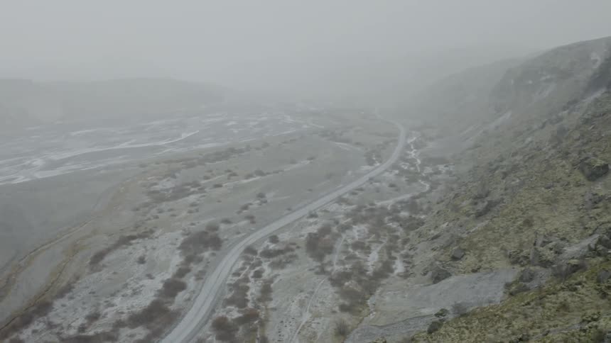 The snow is falling fast over the mountain range