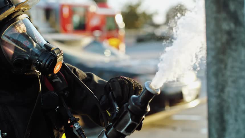 A firefighter release water from a hose