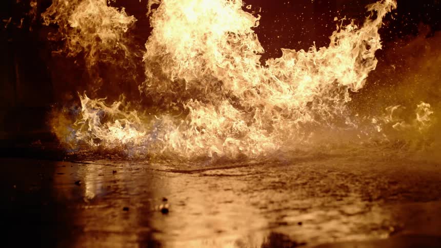 Fire burning out of control out in field at night