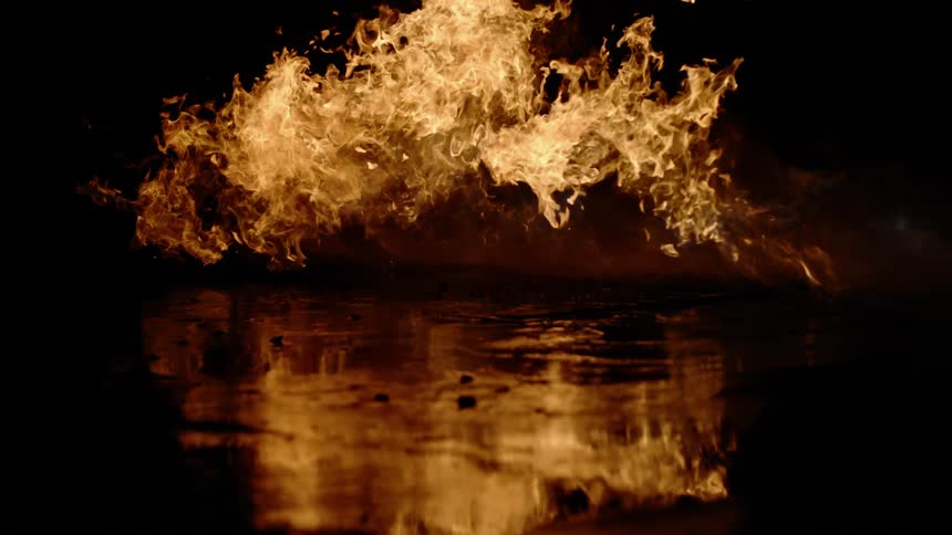 Flames go higher and higher as a fire burns on the ground