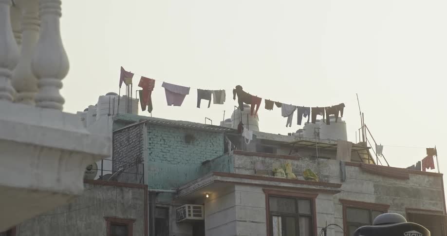 Clothes on clothesline on top of building in India