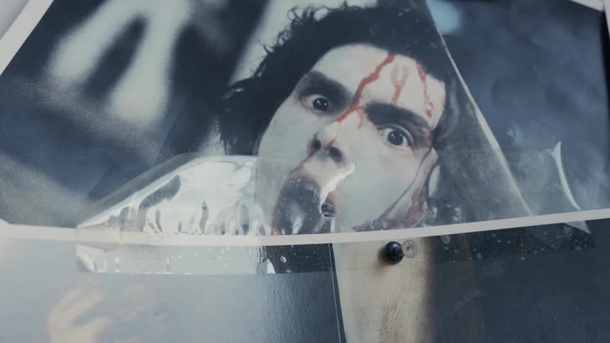 A man in a car covered in blood that appears to be screaming