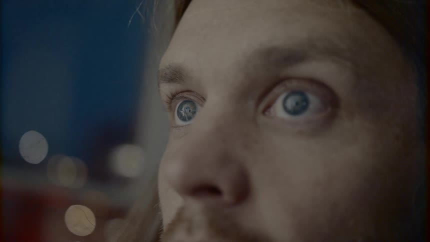 Blonde hair blue eyed man turns the spotlight in the workshop