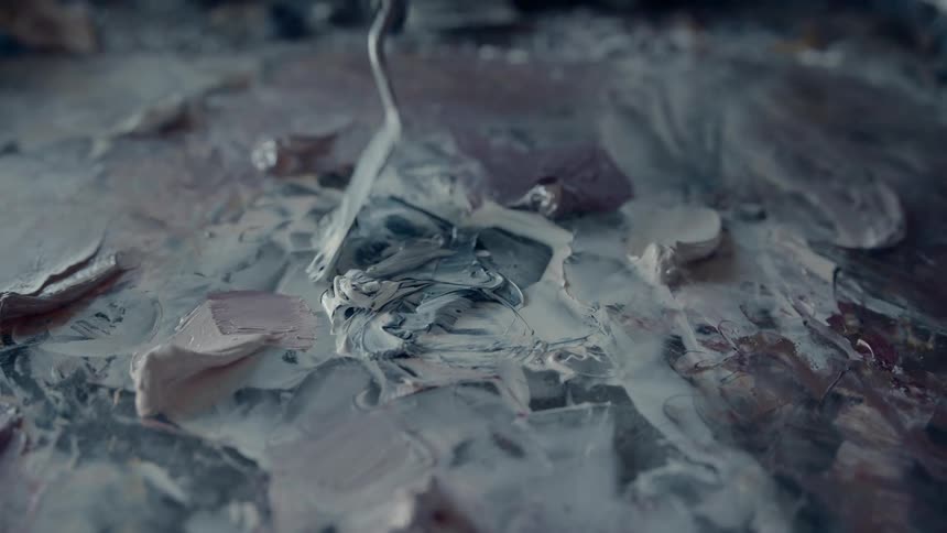 An artist is mixing paint together