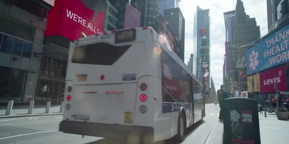 A bus travels ondowntown city street