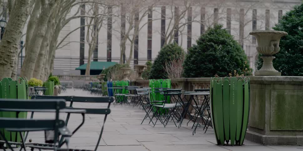 Tables sit empty in a park
