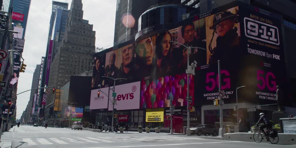 Billboards flash on a city street