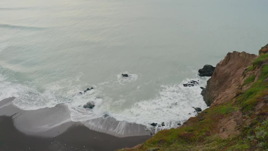 Birds eye view of waves crashing in to the shoreline