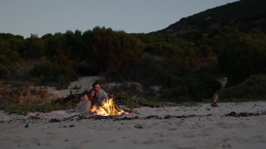Couple Around Fire In Desert