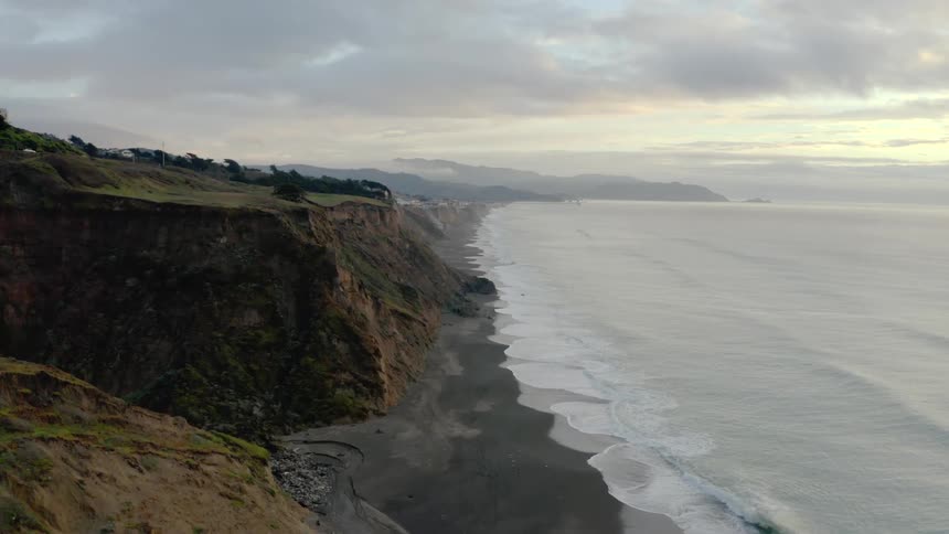 Aerial of the coastline near coves and cliffs