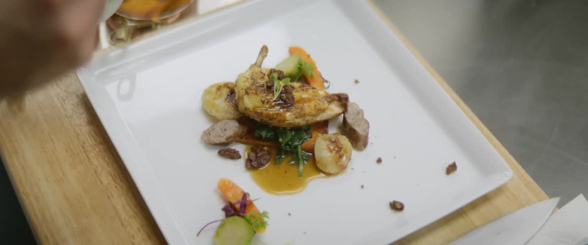 A chef plates an appetizer