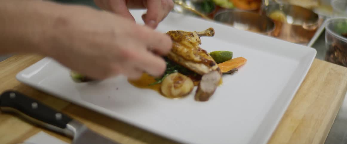 A chef plats an appetizer