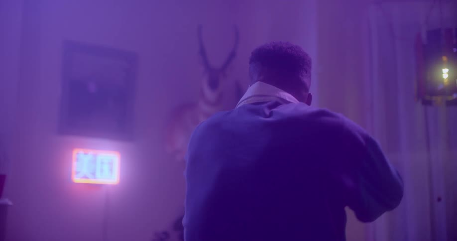 Man dance in purple tinged room