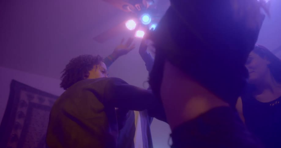 People dancing indoors under colored lights
