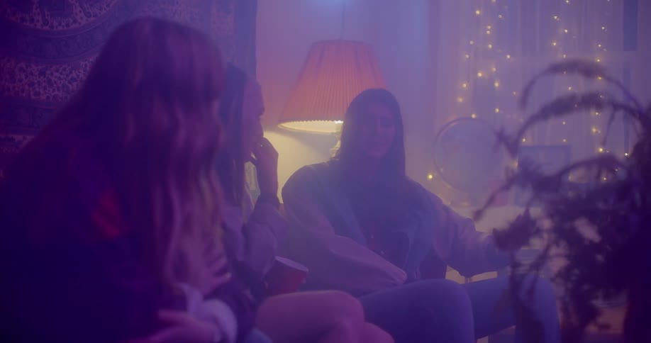 Three woman sitting on a sofa talking