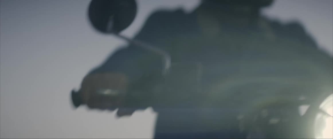 A man rides a motorcycle at night