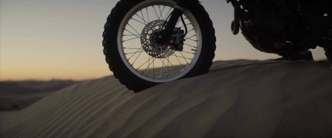 A motorcycle tire on the desert sand