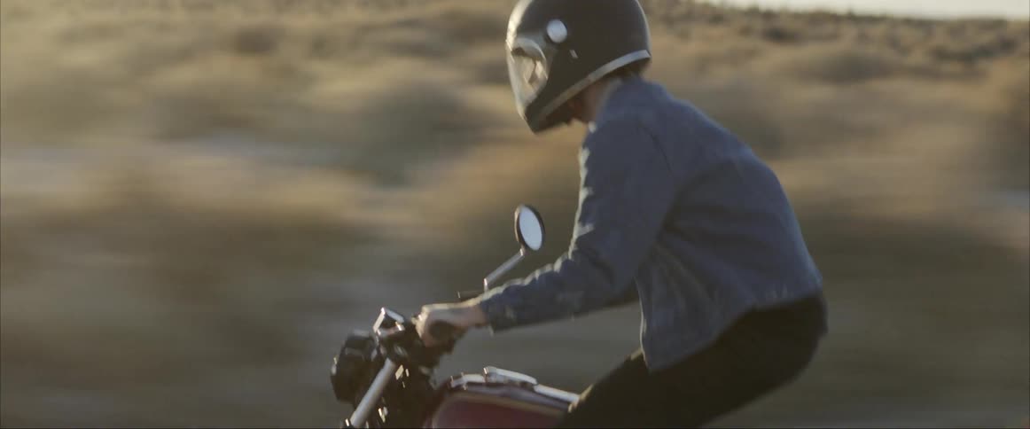 A man is riding a motorcycle outdoors