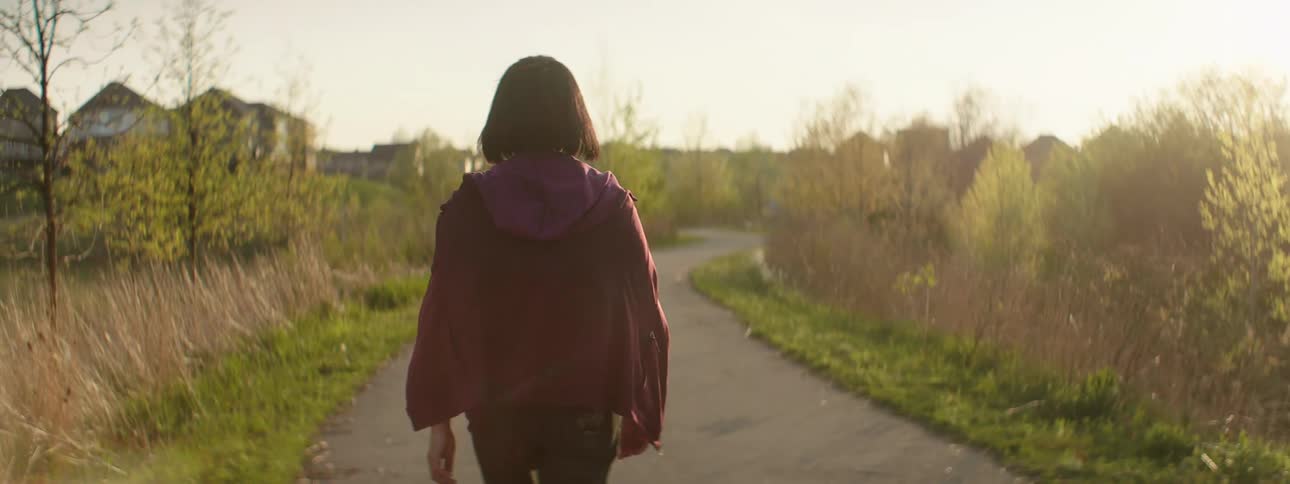 A young girl walks along a path