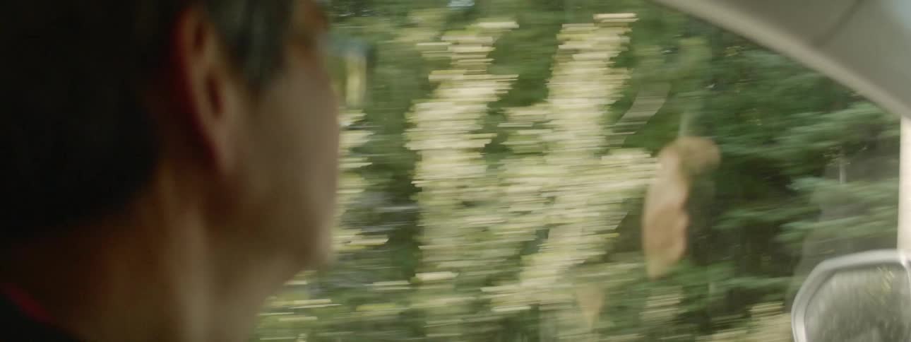 A man drives in a car