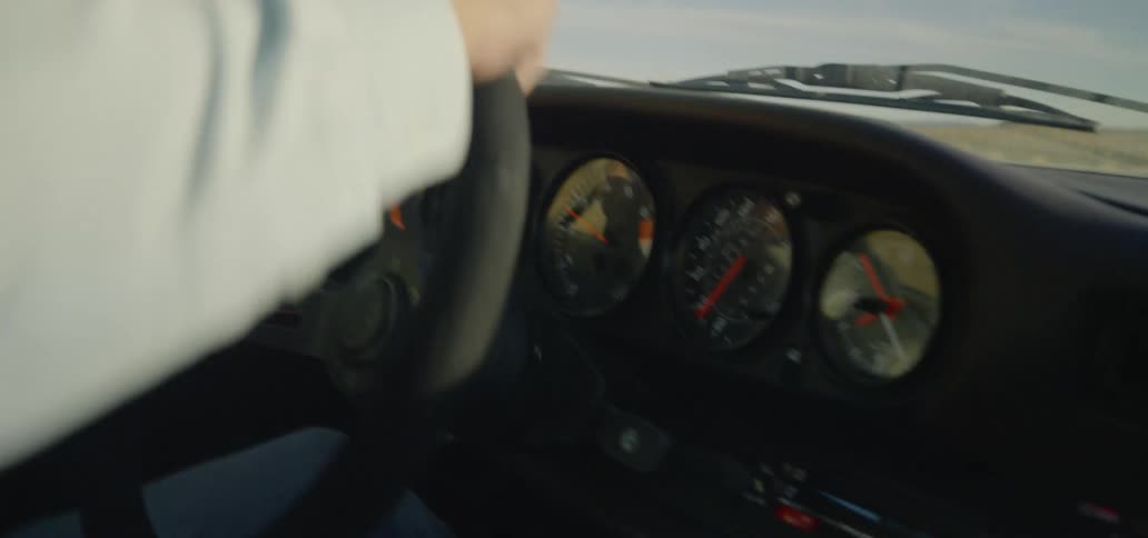 Man driving the car enters the turn at a slow speed
