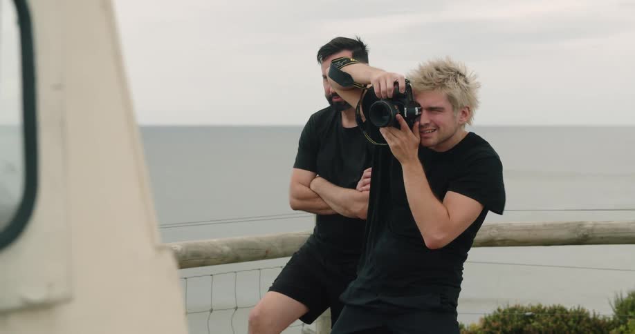 A photographer does a photo shoot on the beach